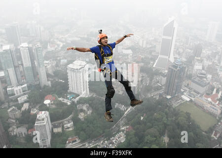 Kl, Kuala Lumpur, Malaysia. 2nd Oct, 2015. Base jumpers leaps from the 300-metre (984 ft.) high .They are piictured against the skyline that shrouded by a thick haze during the Kuala Lumpur Tower International Jump in Kuala Lumpur, Malaysia, 02 October 2015. More than 100 Base jumpers participate in this extreme sport event, which enters its 15th year. The haze hovering over Malaysia is caused by the ongoing plantation and forest fires in the nearby Indonesian provinces of Sumatra and Kalimantan. Credit:  Mohd Hafiz/ZUMA Wire/Alamy Live News Stock Photo