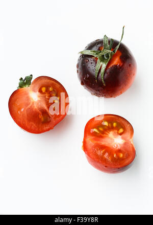 Black cherry tomatoes on white background Stock Photo