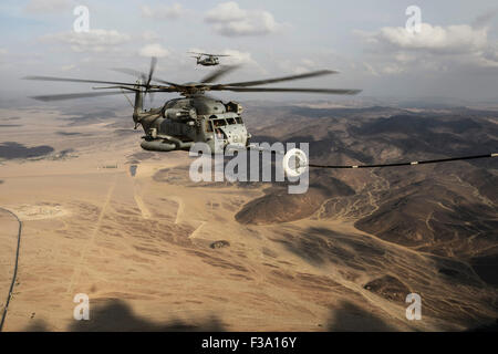 November 15, 2013 - A U.S. Marine Corps CH-53E Super Stallion prepares to refuel from a U.S. Air Force HC-130 during in-air refu Stock Photo