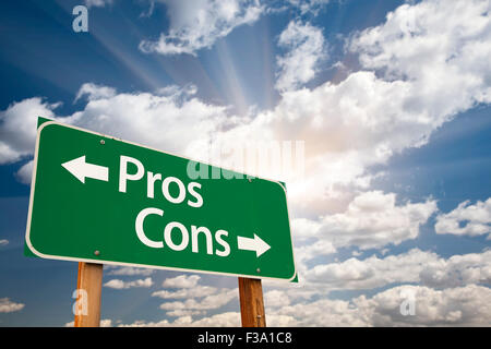 Pros and Cons Green Road Sign With Dramatic Clouds and Sky. Stock Photo