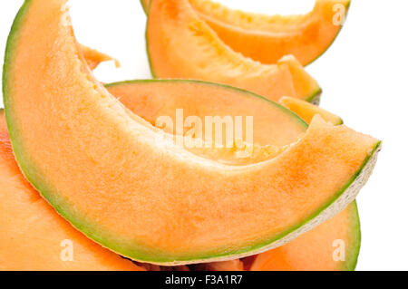 closeup of some slices of Persian melon on a white background Stock Photo