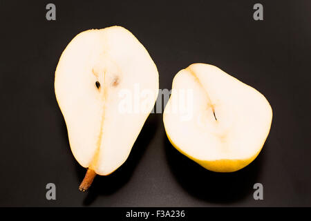 Two halves of a pear isolated on black. Stock Photo