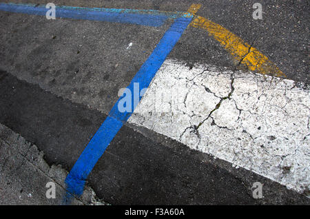 Asphalt road background with yellow, white and blue lines Stock Photo