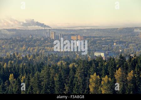 Factory pipes polluting the air in autumn landscape. Smoke rises from the chimney of a industrial plant. HDR image. HDR image. Stock Photo