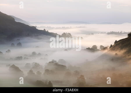 Mist over Windermere seen from above the Great Langdale Valley Stock Photo