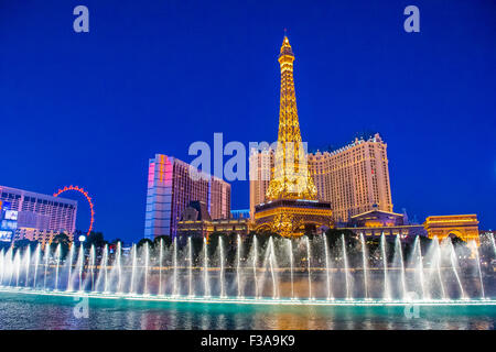 Night view of the dancing fountains of Bellagio and the Eiffel Tower replica of Paris hotel in Las Vegas Stock Photo