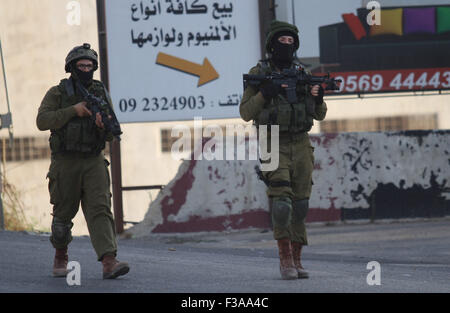 Nablus, West Bank, Palestinian Territory. 3rd Oct, 2015. Israeli soldiers patrol a street, east of the West Bank city of Nablus, on October 3, 2015, as they search for the suspected Palestinian killers of a Jewish settler couple. Hundreds of Israeli troops searched the West Bank for the suspected Palestinian killers of Rabbi Eitam Henkin and his wife Naama shot in front of their young children, the army said Credit:  Nedal Eshtayah/APA Images/ZUMA Wire/Alamy Live News Stock Photo