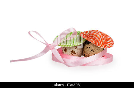 two quail eggs with pink ribbon isolated on white background Stock Photo
