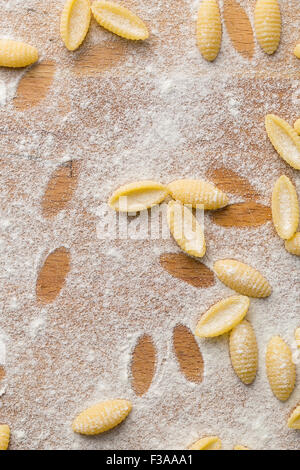 top view of uncooked italian pasta with flour Stock Photo