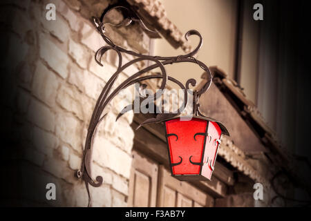 street old lanterns on the wall of a stone house Stock Photo