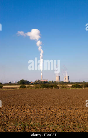 Cottam power station in England.  Cooling towers with smoke coming from cooling towers