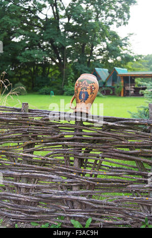Clay jug on fence, a village tradition in Ukraine Stock Photo