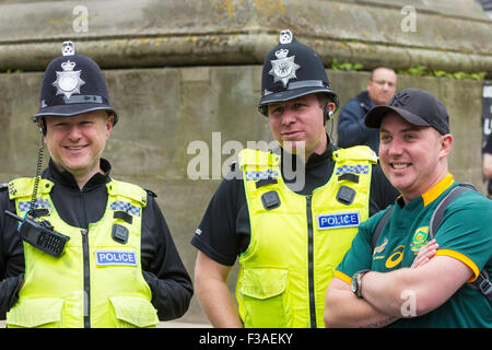 Newcastle upon Tyne, UK. 3rd October, 2015. A great atmosphere as fans gather in Newcastle city centre ahead of this afternoon`s game between South Africa and Scotland as fans gather in the city centre. PICTURED: A South Africa fan having photo taken with the local constabulary. Credit:  Alan Dawson News/Alamy Live News Stock Photo