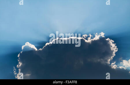 bright sunbeams breaking through the dark cloud Stock Photo