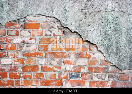 old crumbling brick wall with cracked plaster Stock Photo
