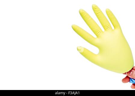Hand Holding Blown Up Latex Glove Yellow Stock Photo