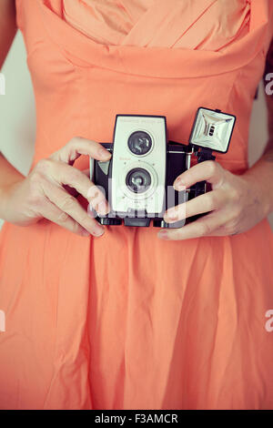 Young vintage woman holding a camera Stock Photo