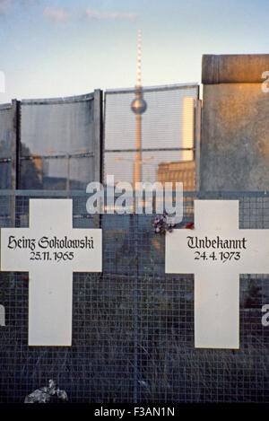 Memorials in West Berlin to those killed crossing from the East, 1985. The Television Tower in East Berlin is in background Stock Photo