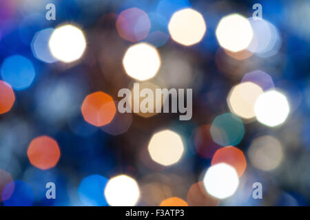 abstract blurred background - blue shimmering Christmas lights bokeh of electric garlands on Xmas tree Stock Photo