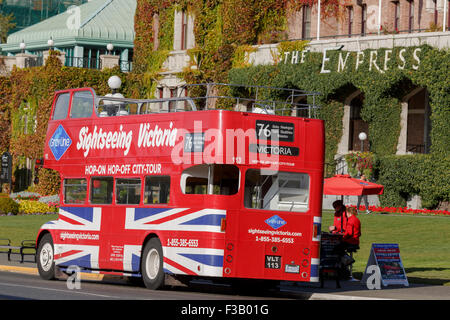 British red double deck tour bus open top in front of Empress Hotel Victoria British Columbia Stock Photo