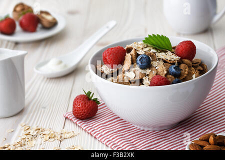 Healthy breakfast with multigrain natural flakes , raspberries, blueberries and almonds. Stock Photo