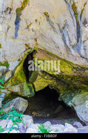 Cave entrance with natural light Caucasus mountains Stock Photo