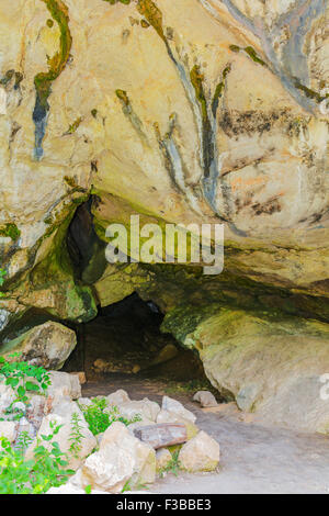 Cave entrance with natural light Caucasus mountains Stock Photo