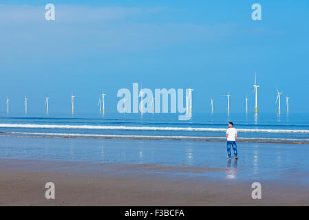 Man standing on the beach at Redcar, Cleveland, England UK Stock Photo