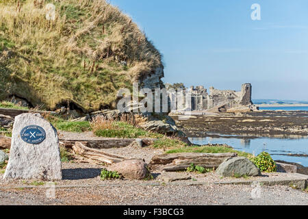 The harbour in St. Andrews Fife Scotland with the castle ruin in the background and Saint Andrews Society stone with plaque Stock Photo