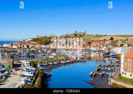 View over the fishing port of Whitby with the Abbey on the hilltop, North Yorkshire, England, UK Stock Photo
