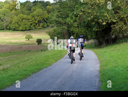 three cyclists on an english rural trail Stock Photo