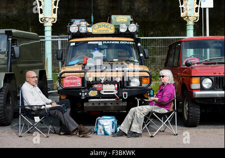 Brighton UK Sunday 4th October 2015 - This couple enjoy a cup of tea in front of their vehicle as Hundreds of Land Rover and Range Rover owners take part in the 17th London to Brighton Land Rover Run which finished on Madeira Drive on the seafront  Credit:  Simon Dack/Alamy Live News Stock Photo