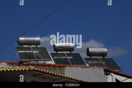 Solar water heaters on a roof top in the small Greek village of Giolova in the Peloponnese. Stock Photo