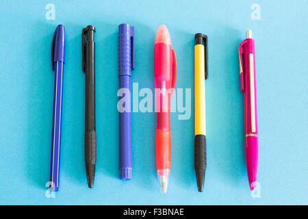 Colourful pens on a blue background Stock Photo