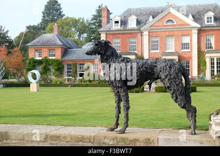 Newport House, Almeley, Herefordshire UK - Sunday 4th October 2015 - Opening day for the Out of Nature sculpture exhibition featuring over 200 pieces of work from 40 artists displayed in the formal gardens of Newport House. This piece is titled Standing Dog by artist Sally Matthews and made from bronze. The exhibition runs until October 25th 2015. Stock Photo