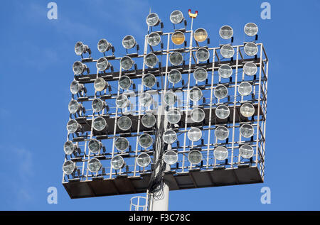 Stadium lights against blue sky background Stock Photo