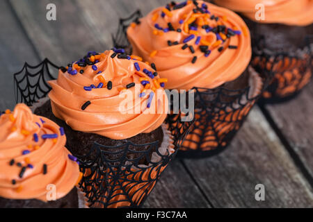 Festive Halloween cupcakes on vintage wooden background Stock Photo