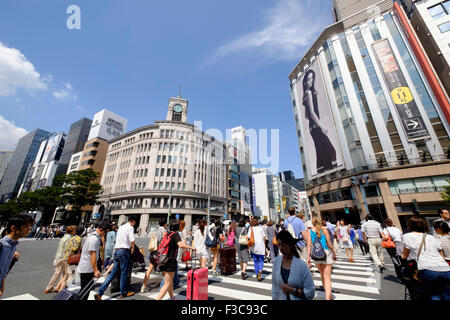 Busy pedestrian crossing  in upmarket shopping district of Ginza in Tokyo Japan Stock Photo