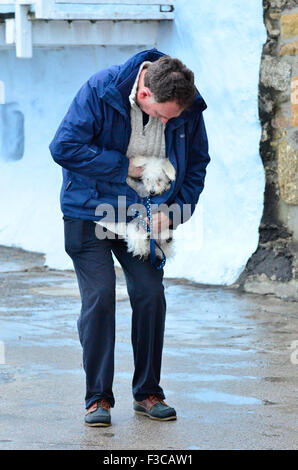 St Ives, Cornwall, UK. 5th October, 2015. UK Weather. Creature Comforts. Small dog is being sheltered from the cold and wet in St Ives Harbor in Cornwall. Credit:  Robert Timoney/Alamy Live News Stock Photo