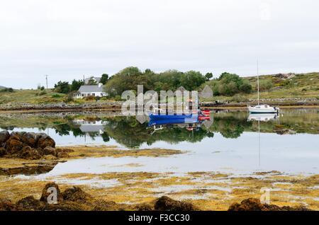 Fishing boats in  still early morning light Inishnee harbour Roundstone Connemara County Galway Ireland Stock Photo