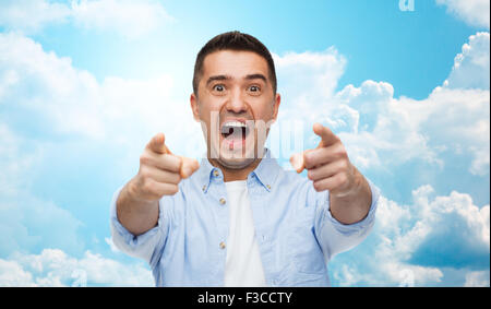 scared man shouting and pointing finger on you Stock Photo