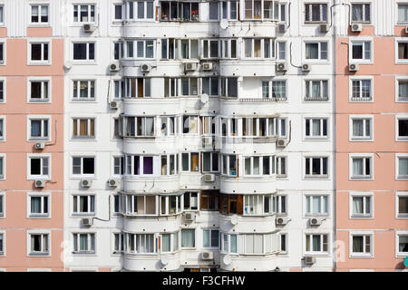 Windows and balconies of old many floors  inhabited town mass production  house background. Sunny autumn day urban landscape Stock Photo