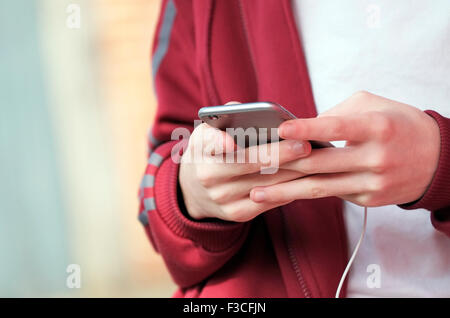 young male teenager using mobile phone Stock Photo