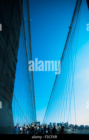 Tourists walking on the Brooklyn Bridge in New York City, New York State, USA Stock Photo