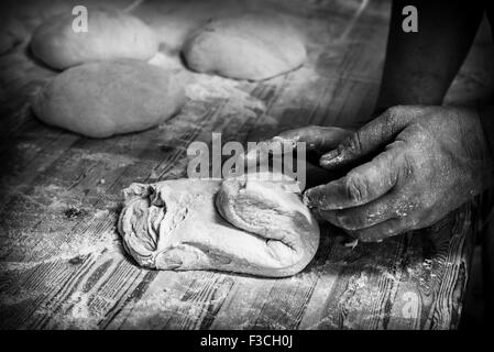 Baker kneading dough, cropped Stock Photo