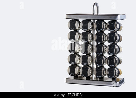 Collection of spice jars in a stainless steel rack. Stock Photo
