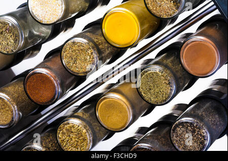 Glass bottles in a spice rack. Stock Photo