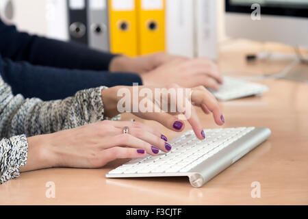 Female fingers typing on keyboard Stock Photo