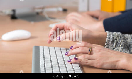 Female fingers typing on keyboard Stock Photo