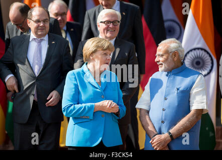 New Delhi, India. 05th Oct, 2015. New Dehli, India. 05th Oct, 2015. German chancellor Angela Merkel and Indian Prime Minister Narendra Modi speak as they pose on the stairs to the Hyderabad House for a group picture after the third Indian-German intergovernmental consultations in New Dehli, India, 05 October 2015. German Foreign Minister Steinmeier stands behind Merkel. Modi are scheduled to lead the third inter-governmental consulta Credit:  dpa/Alamy Live News Stock Photo